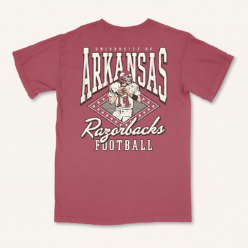 A maroon short-sleeve t-shirt with a large back graphic featuring the text 'University of Arkansas Razorbacks Football' and an illustration of a football player, shown on a plain white background.