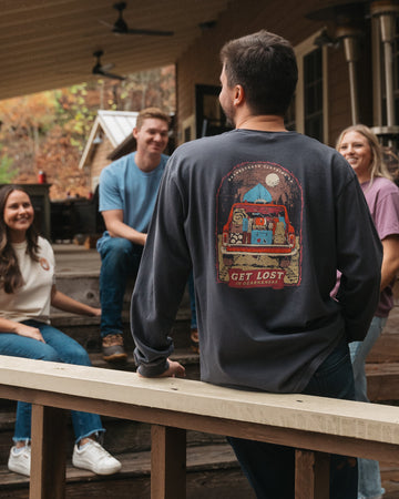 Group of people at a cabin in the woods during a perfect Arkansas fall day