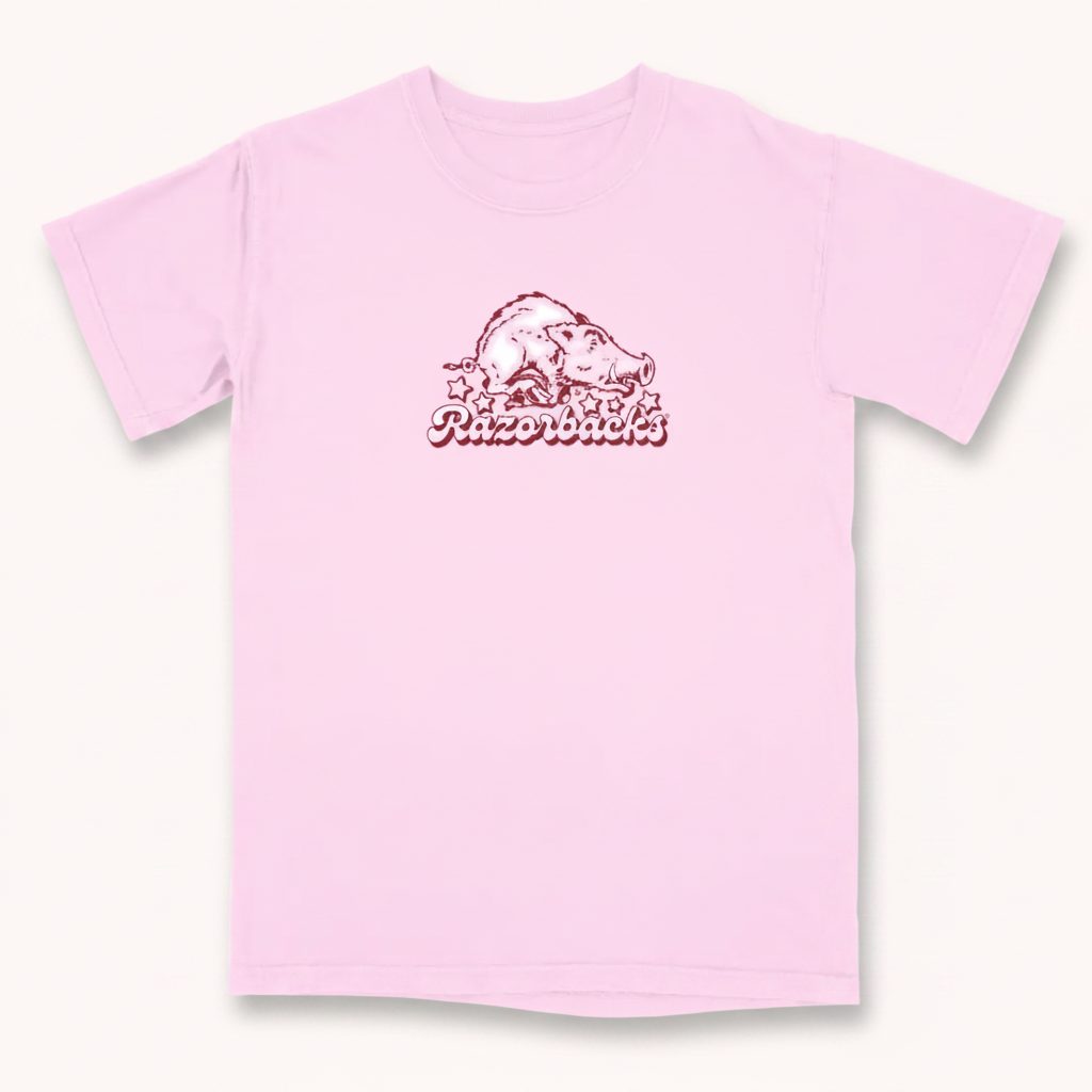 A light pink short-sleeve t-shirt with a distressed dark red graphic of a razorback hog and the word 'Razorback' on the chest, displayed on a solid white background.