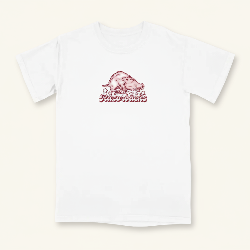A white short-sleeve t-shirt featuring a red graphic of the Arkansas Razorbacks hog logo and the word 'Razorbacks' printed on the chest, displayed against a clean white background.