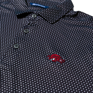 Close-up of a dark Black polo shirt with a white micro-dot pattern and a red embroidered Slobbering Hog Razorback logo on the chest.