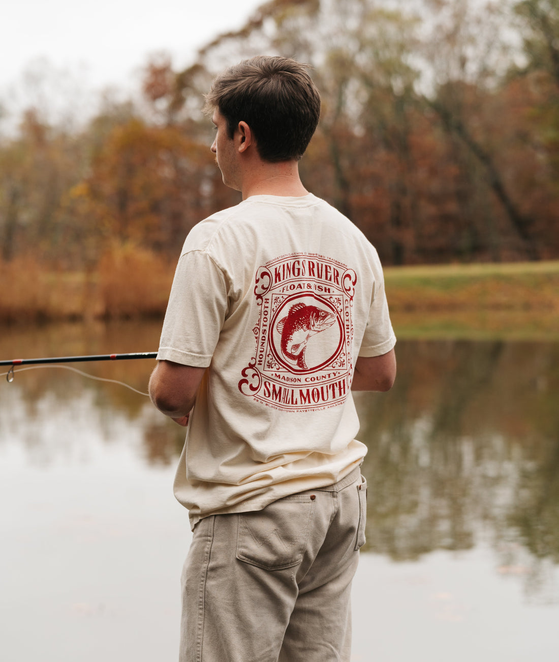 Cream colored t shirt with a red drawing of a small mouth bass flailing on Kings River.